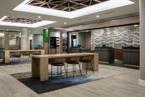 a lobby with a reception desk and stools at Courtyard by Marriott Chicago Downtown/River North in Chicago