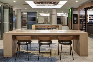 a large island in a lobby with three bar stools at Courtyard by Marriott Chicago Downtown/River North in Chicago