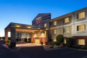 a hotel building with a hotel sign and a parking lot at Fairfield Inn & Suites by Marriott Odessa in Odessa