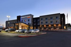 a building with cars parked in a parking lot at Fairfield Inn & Suites by Marriott Sacramento Airport Woodland in Woodland