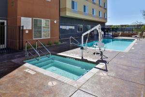 a swimming pool in front of a building at Fairfield Inn & Suites by Marriott Sacramento Airport Woodland in Woodland