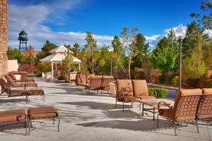 a row of chairs sitting on a patio at SpringHill Suites Lehi at Thanksgiving Point in Lehi