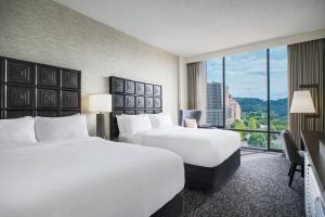 a hotel room with two beds and a large window at Renaissance Asheville Downtown Hotel in Asheville