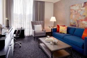 a living room with a blue couch and a chair at Renaissance Asheville Downtown Hotel in Asheville