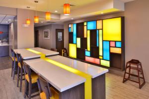 a conference room with tables and chairs and stained glass at TownePlace Suites by Marriott Laplace in Laplace