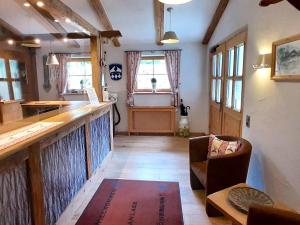 a living room with a bar and a table at Stellar Apartment in Bayrischzell with 2 Sauna, Garden and Terrace in Bayrischzell