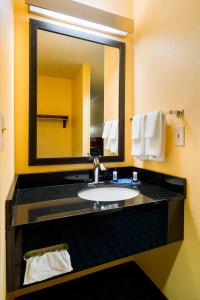 a bathroom with a sink and a large mirror at Fairfield Inn & Suites by Marriott Allentown Bethlehem/Lehigh Valley Airport in Bethlehem