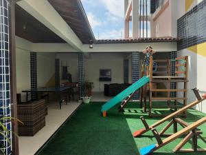a play area with a slide in a house at Casa com piscina a 500m da praia in Salinópolis