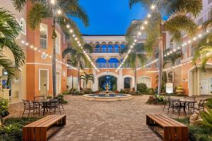 a courtyard with tables and chairs in a building with lights at Marriott's Grande Vista in Orlando