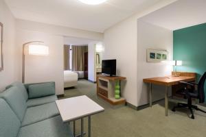 a living room with a couch and a desk at SpringHill Suites by Marriott Pittsburgh Washington in Washington