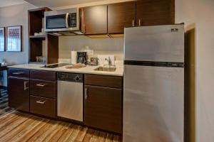 a kitchen with a stainless steel refrigerator and a sink at TownePlace Suites by Marriott Auburn University Area in Auburn