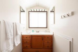 a bathroom with a sink and a window and towels at 30 PCT OFF! Malibu Serene Cottage with King Bed, Beach, BBQ in Malibu +17 photos