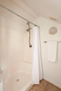 a bathroom with a shower with a shower curtain at Malibu Peaceful Cottage, Near Beach & Hiking Trails in Malibu