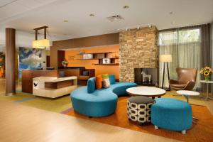 a living room with blue furniture and a fireplace at Fairfield by Marriott Inn & Suites Knoxville Turkey Creek in Knoxville