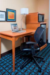 a desk with a laptop and a chair in a hotel room at Fairfield Inn & Suites Waco South in Waco