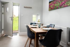 a dining room with a wooden table and chairs at Millers Cottage in Berwick-Upon-Tweed