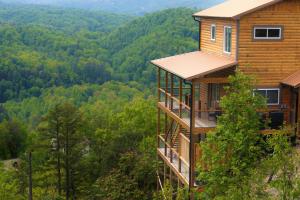 a house on a hill with a view of a forest at 7 BEARS Stunning views in Sevierville