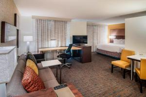 a hotel room with a couch and a bed at Residence Inn by Marriott Rapid City in Rapid City
