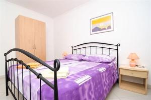 A bed or beds in a room at Apartments Baltazar