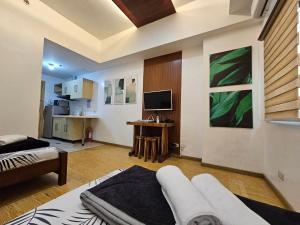 a living room with a couch and a tv in a room at CedarPeak419 in Baguio