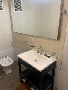 a bathroom with a sink and a mirror and a toilet at Dto. CIVICO ART - PLENO CENTRO in San Juan