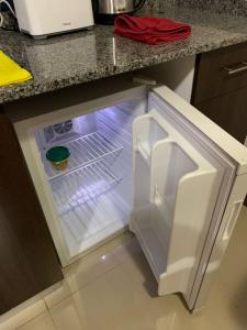 an empty refrigerator with its door open in a kitchen at Dto. CIVICO ART - PLENO CENTRO in San Juan