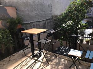 a wooden table and chairs sitting on a patio at Titan House in İzmir +35 photos
