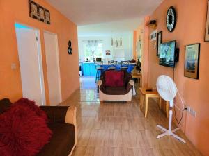 a living room with a couch and a table at Comfort Suites - Two Bedroom Apartment in Choiseul