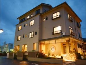 a large building with lights on in front of it at Daigo - Vacation STAY 07995v in Kanayama