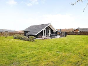 a small house in a field with a grass yard at Holiday home Sydals XL in Neder Lysabild