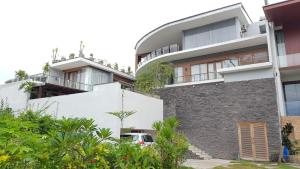 an apartment building with a car parked in front of it at Bougenville Villa in Mangsit