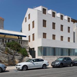 three cars parked in front of a building at Apartment Toni Delux in Split