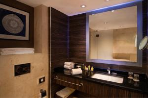 a bathroom with a sink and a mirror at Armenia Marriott Hotel Yerevan in Yerevan