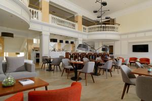 a restaurant with tables and chairs and a bar at Armenia Marriott Hotel Yerevan in Yerevan