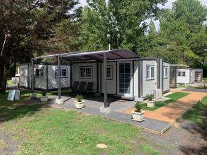 a tiny house with a canopy in a yard at Blue Sapphire Motor Inn in Glen Innes