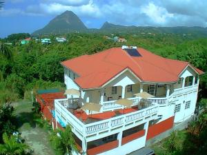 an aerial view of a house with a red roof at Comfort Suites - Two Bedroom Apartment in Choiseul