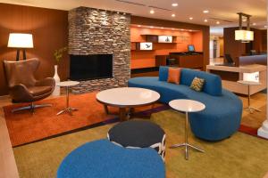 a living room with blue furniture and a fireplace at Fairfield Inn & Suites by Marriott Santa Cruz in Santa Cruz