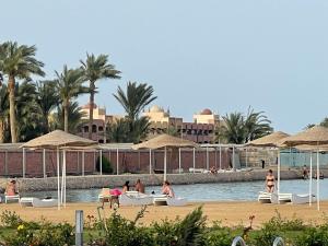 a group of people sitting in boats on the beach at Domi Chalet in Hurghada