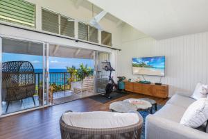 a living room with a view of the ocean at Pali Ke Kua 207 in Princeville