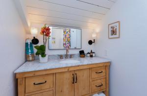 a bathroom with a sink and a mirror at Pali Ke Kua 207 in Princeville +20 photos