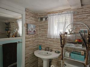 a bathroom with a sink and a toilet at Memories by the Shore in Negril