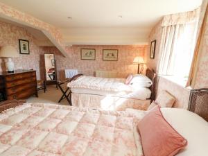 a bedroom with a bed and a window at The Garden Rooms Lawkland in Austwick