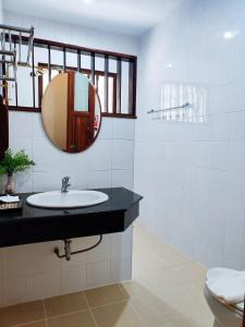 a bathroom with a sink and a mirror at Nan Bluesky Resort and Spa in Nan