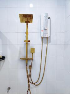 a bathroom with a water hose hooked up to a shower at Nan Bluesky Resort and Spa in Nan
