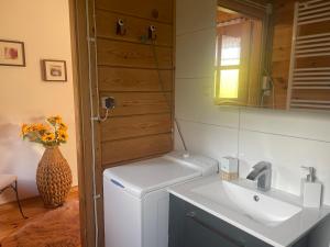 a small kitchen with a sink and a refrigerator at DOM Z BALI Villa Bajkowy Dom in Dźwierzuty