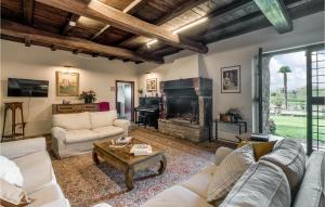 a living room with couches and a fireplace at Villa Arzilla in Vitorchiano