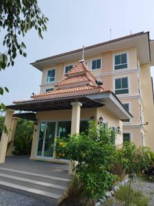 a house with a tiled roof at Wellness World Khao Yai in Ban Wang Sai