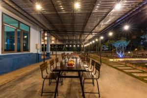 a table and chairs on a patio at night at Cat Ba Spring Garden Private House in Cat Ba