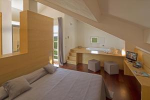 a bedroom with a large bed and a bathroom at Locanda Dell'Angelo in Ameglia