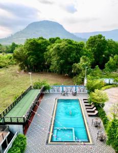 an overhead view of a swimming pool with mountains in the background at Damnak Borey Resort in Kampot